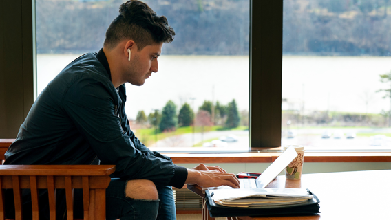 An image of a student studying in the library.
